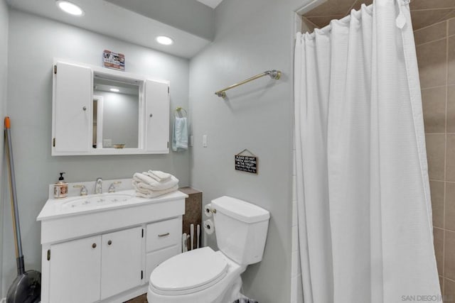 bathroom with vanity, a shower with shower curtain, and toilet