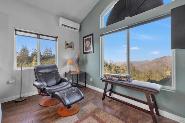 living area with lofted ceiling, a mountain view, dark hardwood / wood-style flooring, and a wall mounted air conditioner