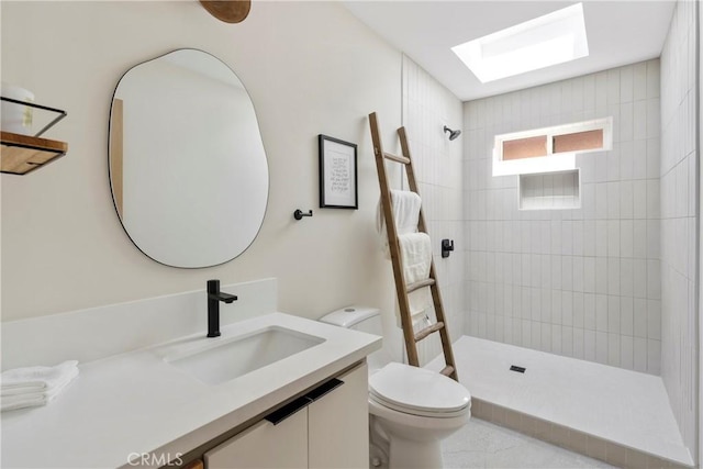 2249 Shoredale Ave, Los Angeles, CA 90031 - bathroom with a tile shower, a skylight, vanity, and toilet