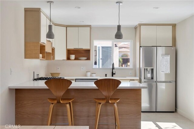 2249 Shoredale Ave, Los Angeles, CA 90031 - kitchen featuring kitchen peninsula, sink, decorative light fixtures, stainless steel fridge with ice dispenser, and a breakfast bar area