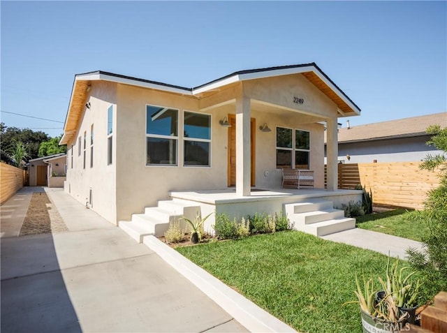 view of front of house with a porch and a front lawn