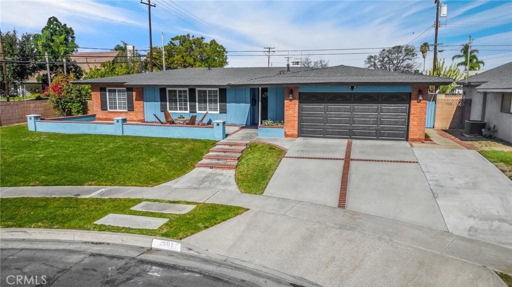 ranch-style home with cooling unit, a front lawn, and a garage