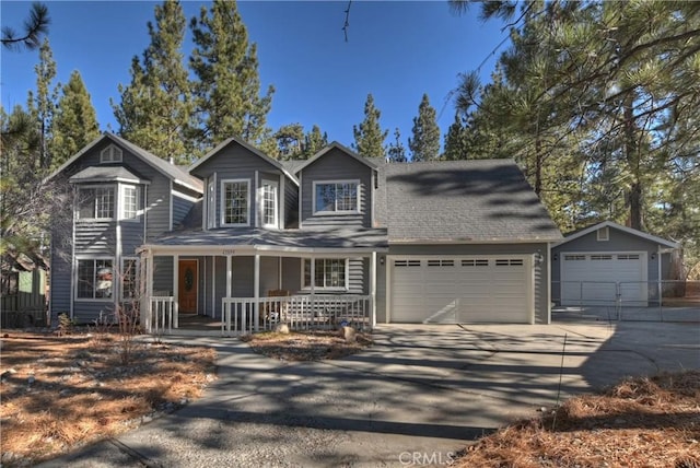 view of front property featuring a porch and a garage