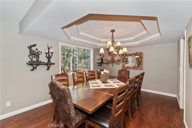 dining room featuring crown molding, a tray ceiling, dark hardwood / wood-style floors, and a chandelier