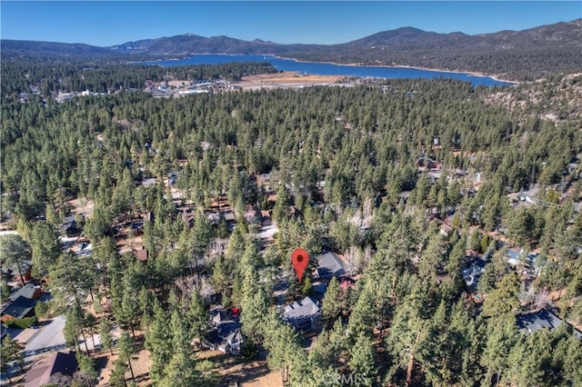 drone / aerial view featuring a water and mountain view