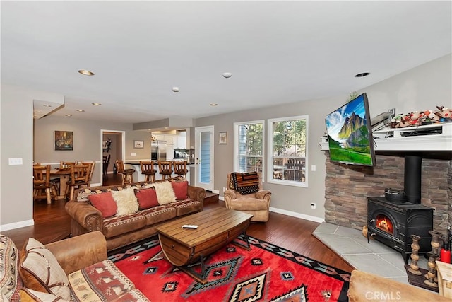 living room with a wood stove and light hardwood / wood-style floors