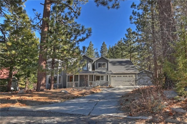 view of front facade featuring a garage and covered porch