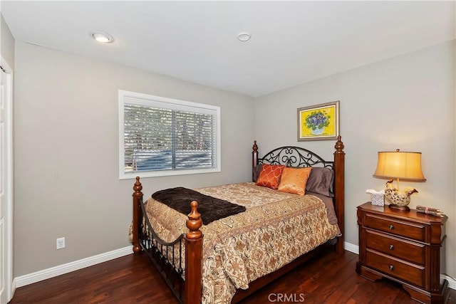 bedroom with dark hardwood / wood-style flooring