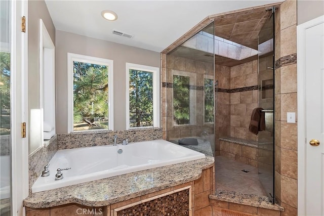 bathroom featuring shower with separate bathtub