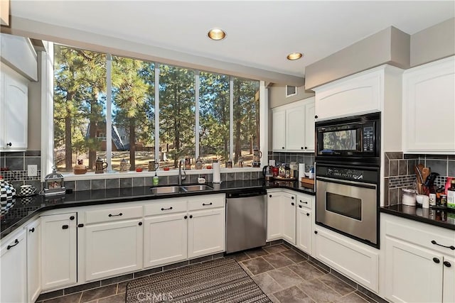 kitchen with white cabinetry, sink, decorative backsplash, and appliances with stainless steel finishes