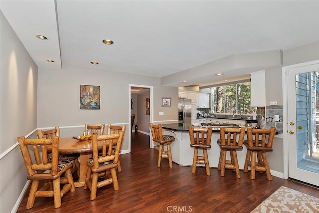 dining space featuring dark hardwood / wood-style flooring and sink