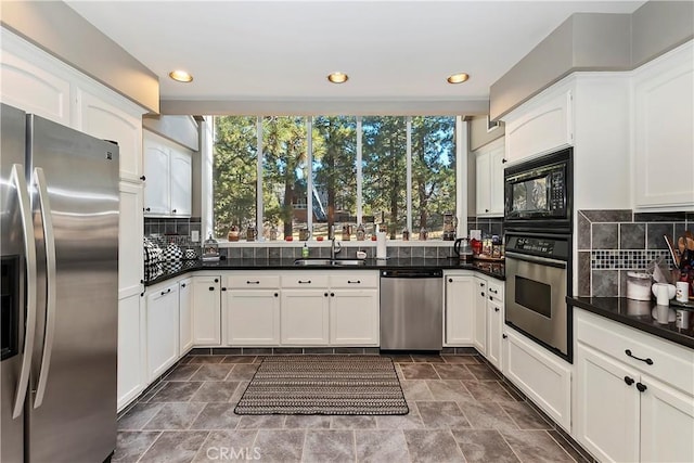 kitchen featuring white cabinetry, appliances with stainless steel finishes, and backsplash