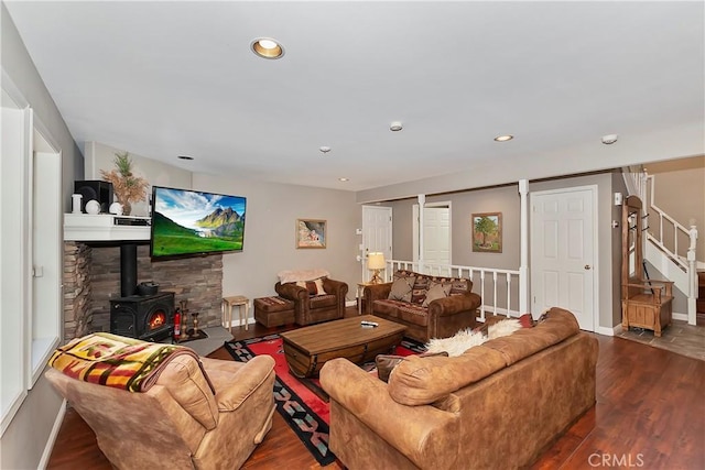 living room featuring dark hardwood / wood-style floors and a wood stove