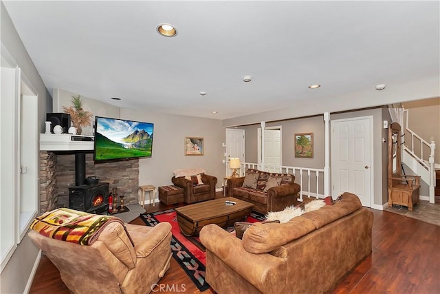 living room featuring dark hardwood / wood-style flooring and a wood stove