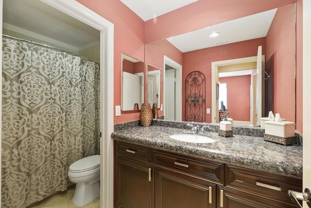 bathroom featuring tile patterned flooring, vanity, and toilet