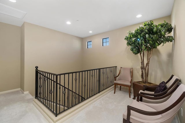 sitting room featuring light colored carpet