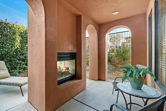 view of patio featuring a multi sided fireplace