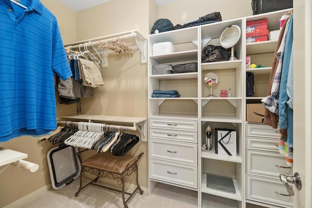 walk in closet featuring light carpet