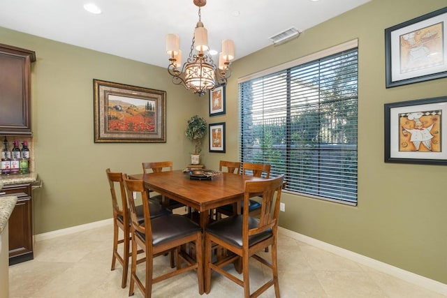 dining room with a notable chandelier and light tile patterned flooring