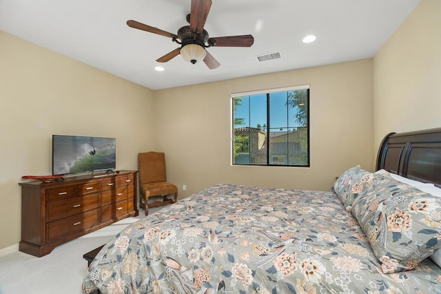 bedroom with ceiling fan and light carpet