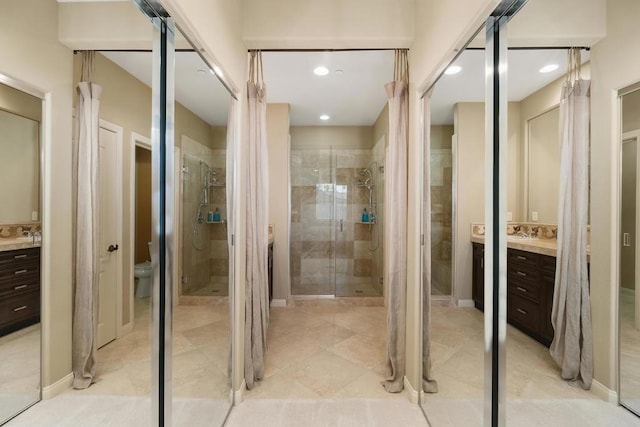 bathroom with toilet, vanity, and walk in shower