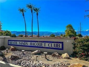 community sign with a mountain view