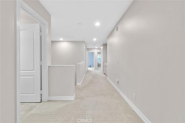 hallway with light colored carpet