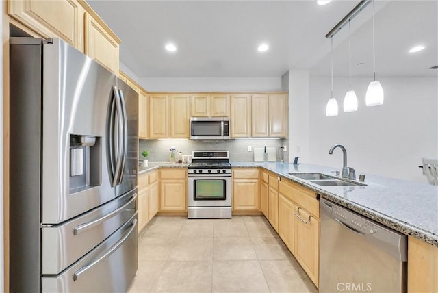 kitchen with light brown cabinetry, tasteful backsplash, stainless steel appliances, sink, and hanging light fixtures