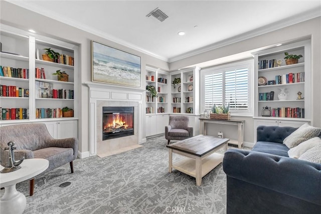 sitting room with a fireplace, built in features, and ornamental molding