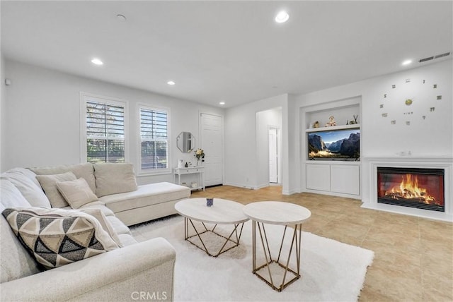 living room featuring built in shelves