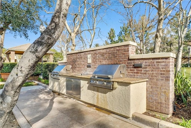 view of patio featuring grilling area and exterior kitchen