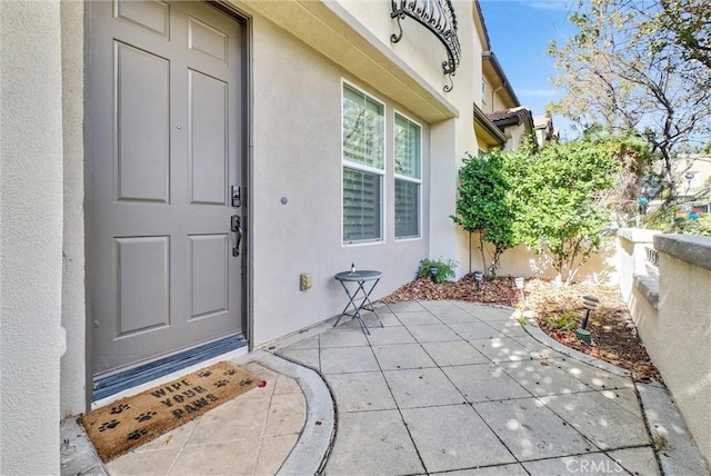 entrance to property featuring a patio area