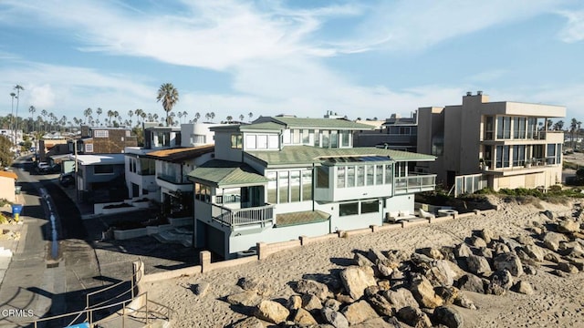 rear view of property featuring a sunroom