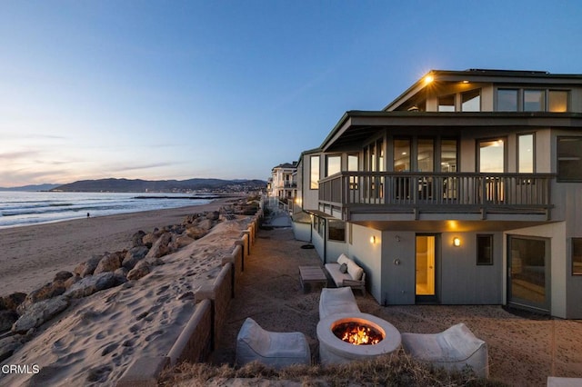 view of snowy exterior featuring a fire pit