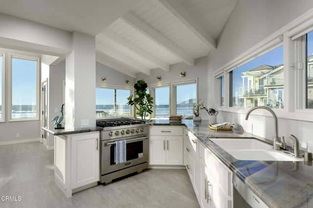 kitchen with sink, white cabinets, vaulted ceiling with beams, kitchen peninsula, and high end stainless steel range