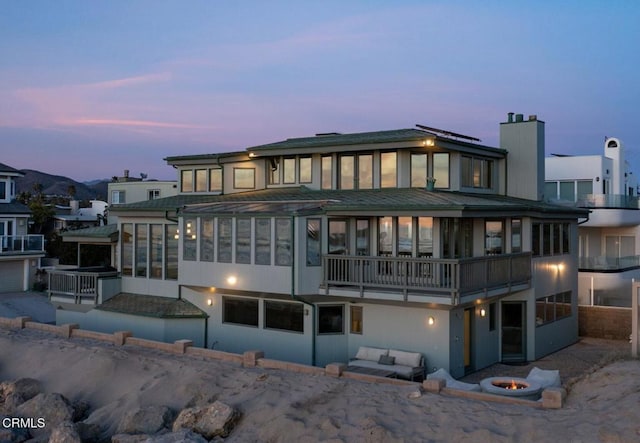 view of back house at dusk