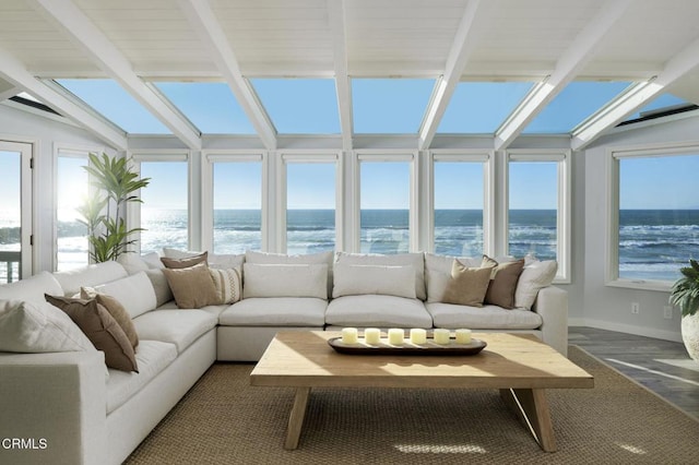 sunroom featuring a wealth of natural light and a water view