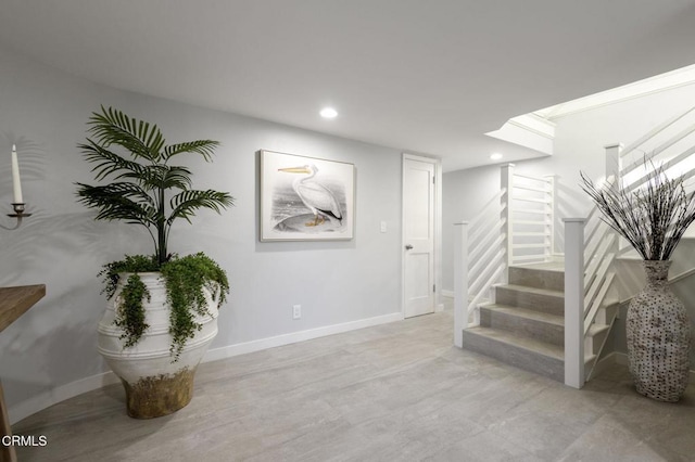 staircase featuring concrete floors