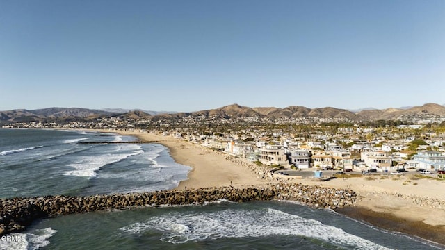 water view featuring a beach view and a mountain view