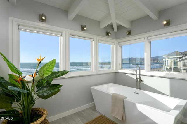 sunroom / solarium featuring wood ceiling, beamed ceiling, and a water view