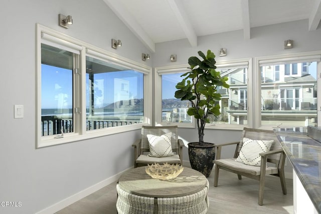 sunroom / solarium with vaulted ceiling with beams