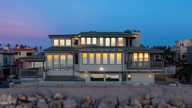 view of back house at dusk