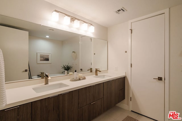 bathroom with tile patterned floors and vanity