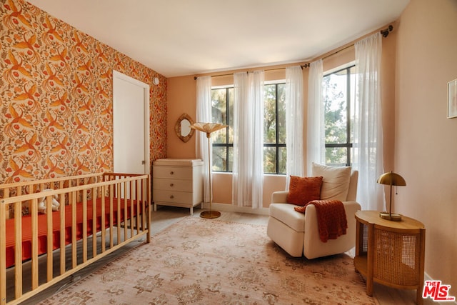 bedroom featuring a nursery area