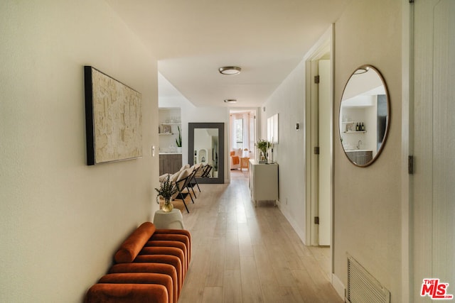 corridor with light wood-type flooring