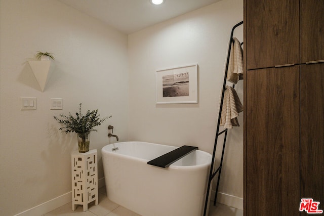 bathroom featuring tile patterned floors and a tub to relax in