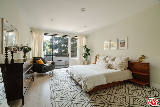 bedroom featuring access to outside and light wood-type flooring