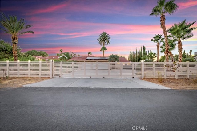 view of garage at dusk