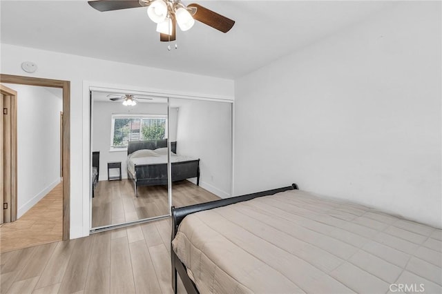 bedroom with light hardwood / wood-style floors, a closet, and ceiling fan