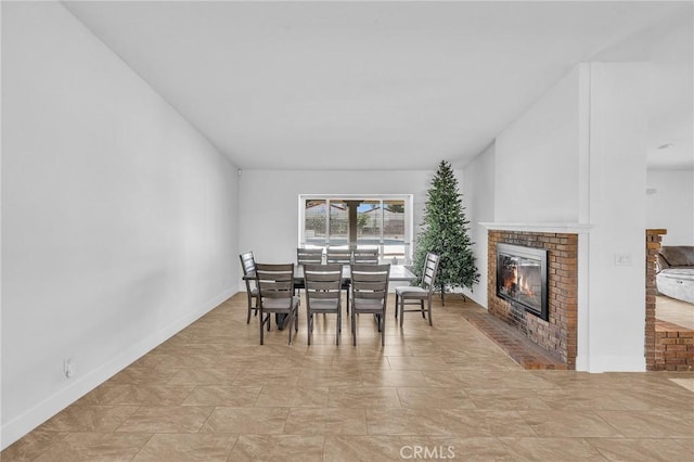 dining area with a brick fireplace